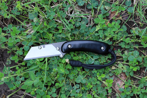 Banzelcroft Customs MEK, a titanium EDC utility knife with black paper micarta handle scales.