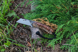 Banzelcroft Customs MEK, a titanium EDC utility knife with stabilized curly koa handle scales and canvas micarta liners.