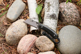 Banzelcroft Customs MEK, a custom titanium EDC utility knife with black linen micarta handle scales and brass liners.