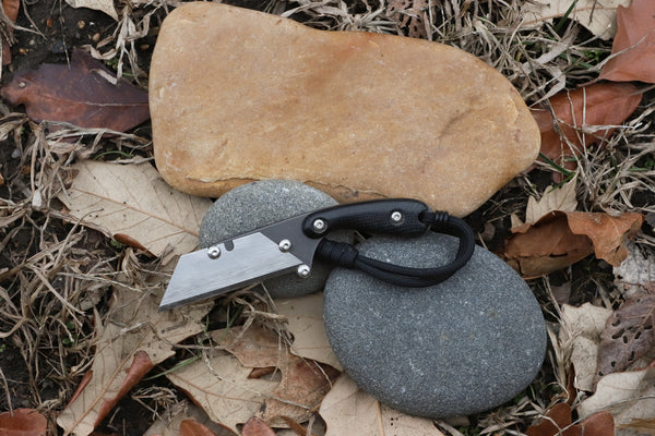 Banzelcroft Customs MEK, a custom titanium EDC utility knife with black canvas micarta handle scales.