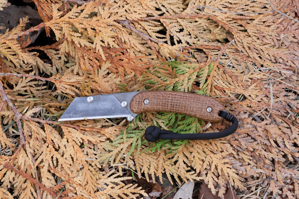 Banzelcroft Customs MEK, a custom titanium EDC utility knife with burlap micarta handle scales.