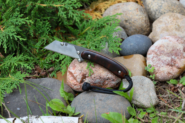 Banzelcroft Customs MEK, a custom titanium EDC utility knife with ironwood burl handle scales and natural linen micarta liners.