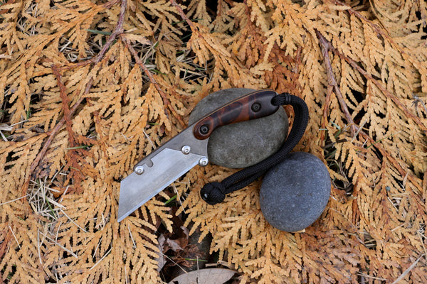 Banzelcroft Customs MEK, a titanium EDC utility knife with ironwood burl handle scales and linen micarta liners.