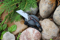Banzelcroft Customs MEK, a custom titanium EDC utility knife with lava kirinite handle scales and copper liners.