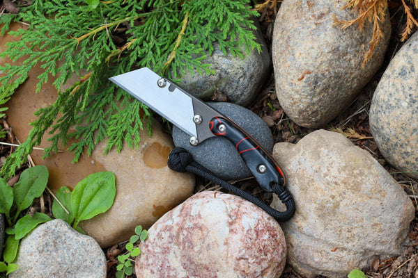 Banzelcroft Customs MEK, a custom titanium EDC utility knife with lava kirinite handle scales and copper liners.