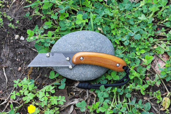 Banzelcroft Customs MEK, a titanium EDC utility knife with a light brown linen micarta handle.