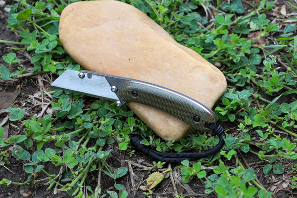 Banzelcroft Customs MEK, a custom titanium EDC utility knife with olive drab canvas micarta and copper handle scales.