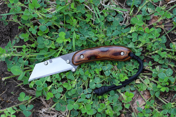 Banzelcroft Customs MEK, a titanium EDC utility knife with python canvas micarta handle scales.