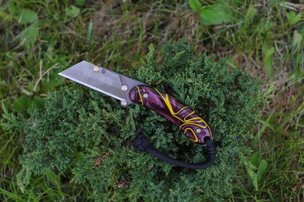 Banzelcroft Customs MEK, a custom titanium EDC utility knife with ultra violet handle scales.