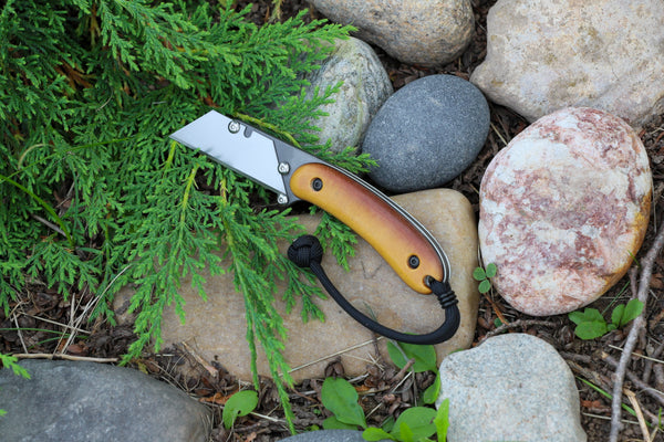 Banzelcroft Customs MEK, a custom titanium EDC utility knife with vintage Westinghouse butterscotch linen micarta handle scales and a black and white double liner.