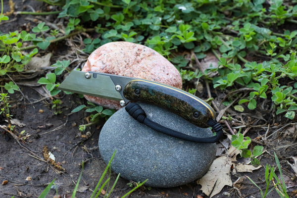 Banzelcroft Customs MEK, a titanium EDC utility knife with vintage rag micarta and brass handle scales.