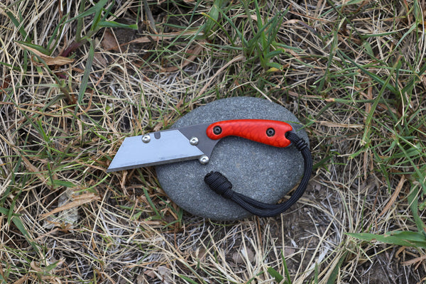 Banzelcroft Customs MEK, a custom titanium EDC utility knife with magma dragon juma handle scales.