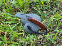  Banzelcroft Customs MEK, a custom titanium EDC utility knife with snakewood handle scales and black liners.