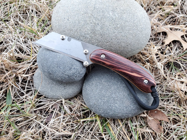 Banzelcroft Customs MEK, a custom titanium EDC utility knife with camatillo handle scales and natural canvas micarta liners.